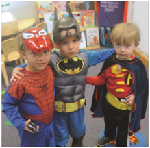 3 young boys posing in super hero costumes